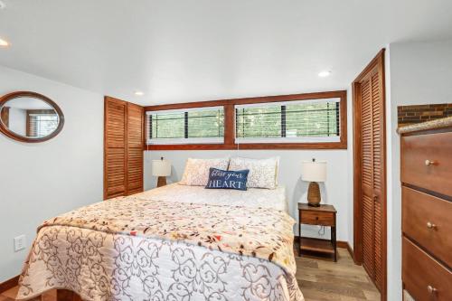 a bedroom with a bed and two windows at Tumble on Inn at Bent Tree Ranch in Lampasas