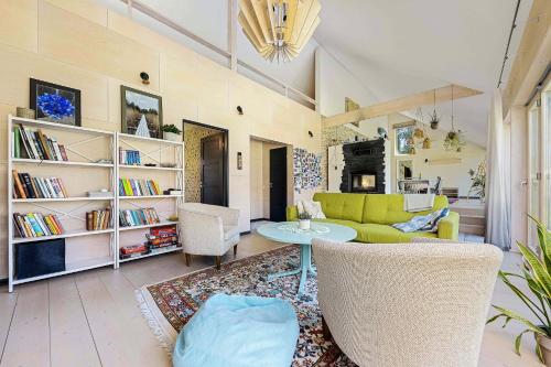 a living room with a couch and a table at Pine forest beach house in Kloogaranna