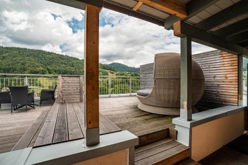 a deck with a couch on top of a house at Wein- und Klimahotel Bergfriedel in Bühlertal