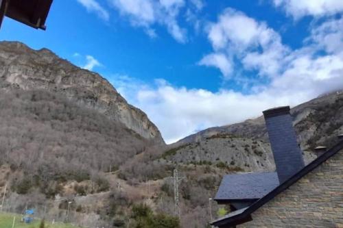 a view of the mountains from a house at Apartamento Tarmañones Vistas a la montaña in Escarrilla