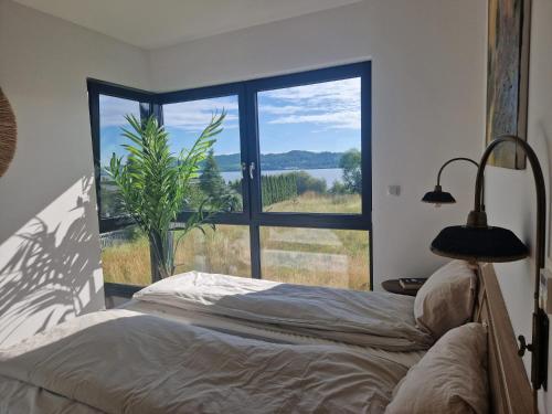 a bedroom with a bed and a large window at Villa Seaview in Nadole