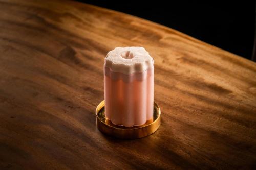 a candle sitting on top of a wooden table at W Singapore - Sentosa Cove in Singapore