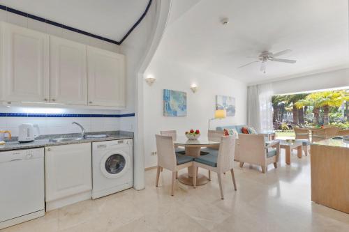 a kitchen and dining room with a table and a dishwasher at Anfi del Mar 1 in La Playa de Arguineguín