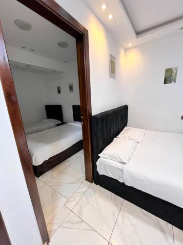 a mirror in a room with two beds at Hi pyramids view in Banī Ghālib