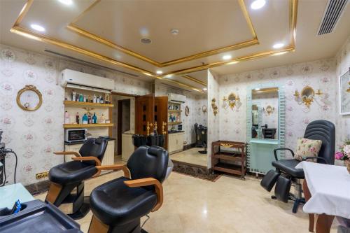 a salon with black chairs and pink wallpaper at Radisson Hotel Jalandhar in Jalandhar