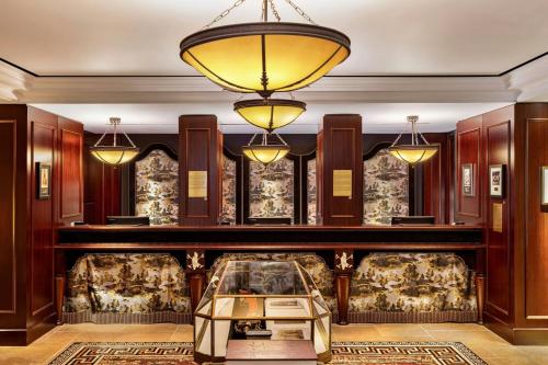 a lobby with a table and chandeliers at Maxwell Reserve Singapore, Autograph Collection in Singapore