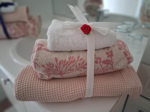 three towels stacked on top of each other on a counter at Les mésanges bleu in Malmedy