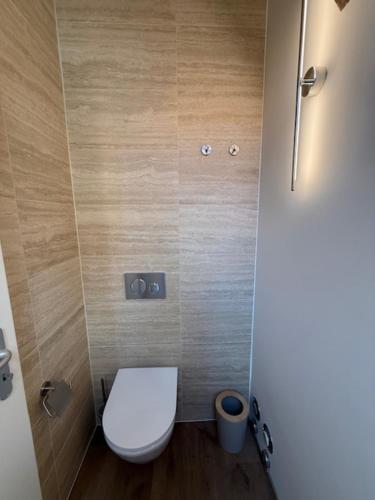 a bathroom with a white toilet in a stall at V&V Serenity in Neuchâtel