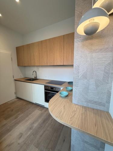 a kitchen with a table and a counter top at V&V Serenity in Neuchâtel