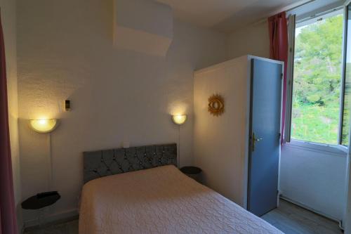 a bedroom with a bed and a window at Le Telo in Saint-Mandrier-sur-Mer