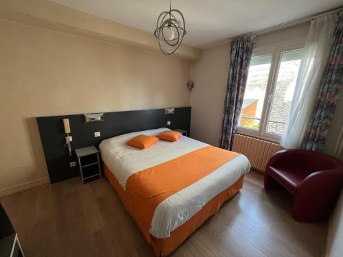 a bedroom with a bed and a chair and a window at Logis Hôtel & Restaurant de la Barque in Beaumont-sur-Sarthe