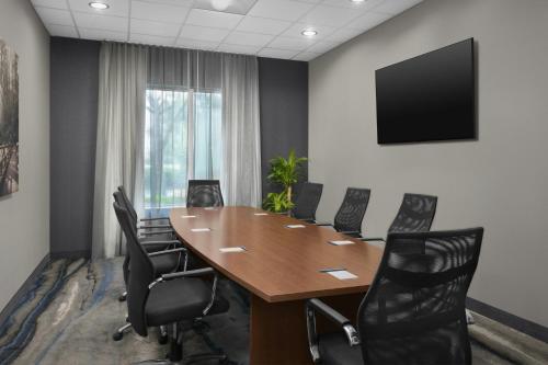 a conference room with a wooden table and black chairs at Fairfield Inn & Suites by Marriott Fayetteville North in Fayetteville