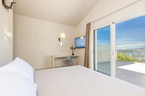 Postel nebo postele na pokoji v ubytování Costa di Baunei Rooms