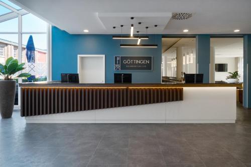 a lobby with a reception desk in a building at Four Points Flex by Sheraton Göttingen in Göttingen