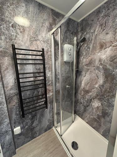 a shower with a glass door in a bathroom at Bh2Beach House,4mins to the beach, centrally located, group stays in Bournemouth