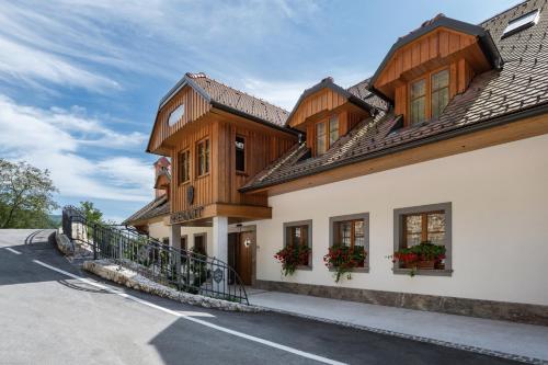 a house with wooden trim and windows on a street at Menart Estate in Cerklje na Gorenjskem