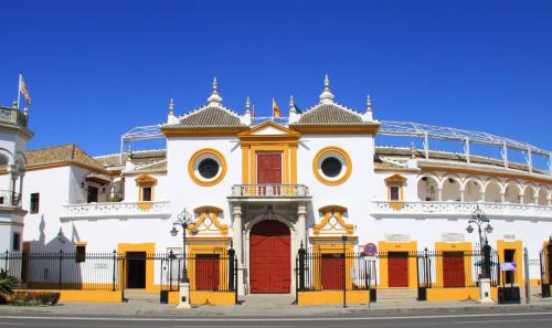 a large white building with a red door at Adriano Boutique Sevilla in Seville