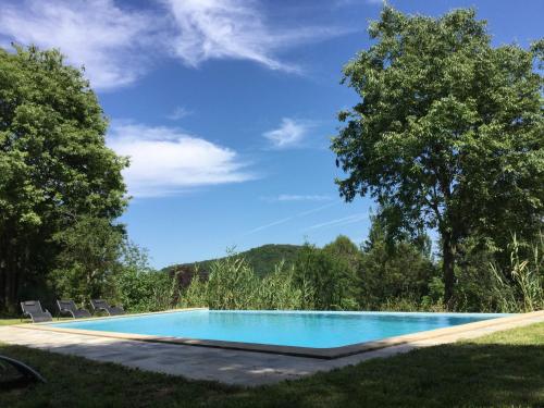 a swimming pool in the yard of a house at Mas Pardas in Santa Pau