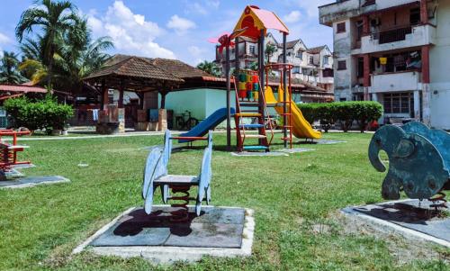 a park with a playground with a slide at Homestay D'Lapang near KLIA in Sepang