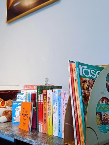 a row of books sitting on a table at Homestay D'Lapang near KLIA in Sepang