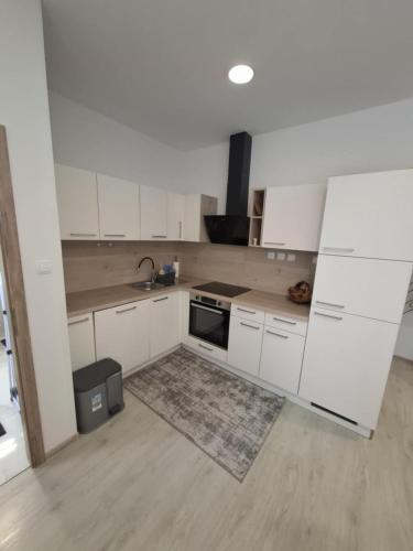 a kitchen with white cabinets and a sink at Prenočišča Dany APARTMA 2 in Dravograd
