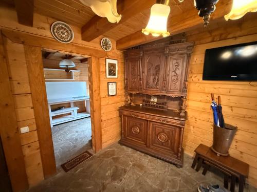 a living room with a tv and a wooden wall at Готель Пацьорка in Kremintsi