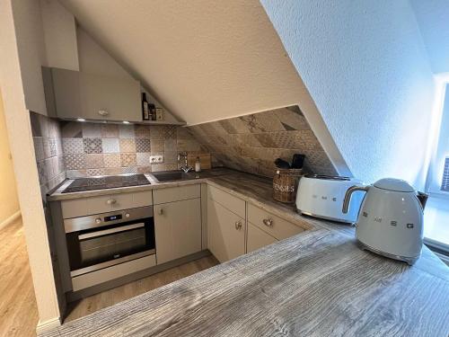 a kitchen with a counter top with a kitchen appliance at Stilvolle 2 5 Zimmer Wohnung unter Reet in SPO mit Garten in Sankt Peter-Ording