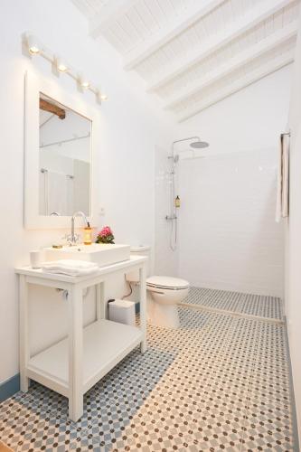a white bathroom with a sink and a toilet at Quinta do Cedro Azul, Douro Valley in Fontelo