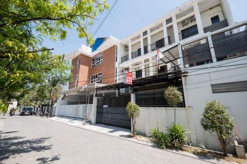 a building on the side of a street at RedDoorz At Graha 99 Simomulyo in Surabaya