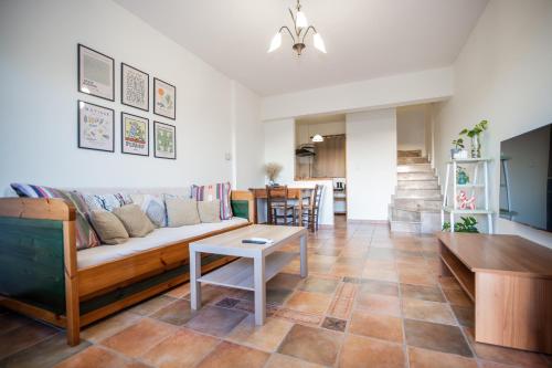 a living room with a couch and a table at Strix Aluco Kalavryta in Kalavrita