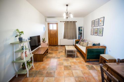 a living room with a couch and a table at Strix Aluco Kalavryta in Kalavrita
