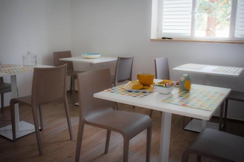 una sala da pranzo con tavoli e sedie con cibo sopra di I MURETTI A SECCO B&B a Castel del Monte