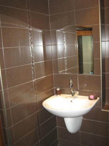 a bathroom with a sink and a mirror at Family Hotel Kedara in Burgas City