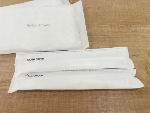 two white envelopes sitting on top of a table at Nishihara Village, Aso District, near the Airport MACOMO in Koga