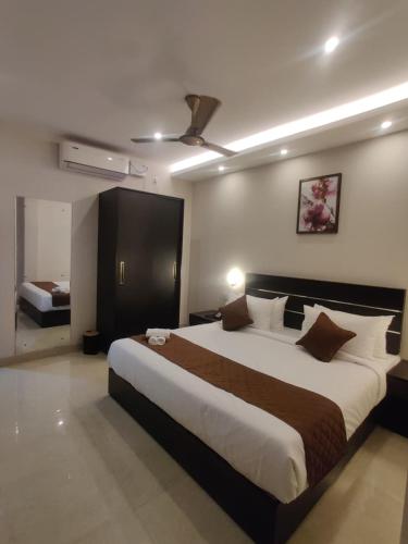 a bedroom with a large bed in a room at Megha Residency in Ernakulam