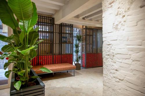a living room with a bench and a plant at Hotel Casa W in Venice