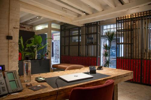 an office with a desk with a laptop on it at Hotel Casa W in Venice