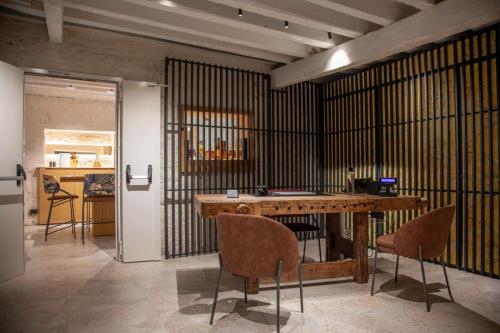 a room with a wooden table and chairs at Hotel Casa W in Venice