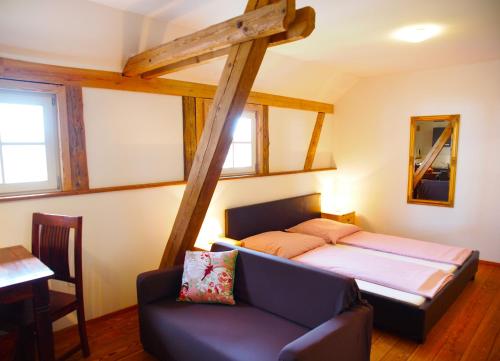 a bedroom with a bed and a couch in a room at Schlossgut Franken - Doppelzimmer Landgarten in Redwitz an der Rodach