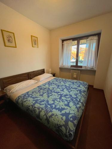 Кровать или кровати в номере Appartamento Sestriere