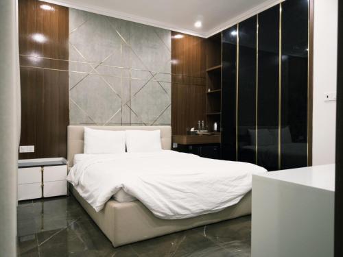 a bedroom with a large white bed and a bathroom at Joie Homestay Huế in Thôn Trường Giang