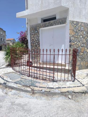 a fence in front of a building with a white door at Bizerte Tunisia cozy studio in Bizerte