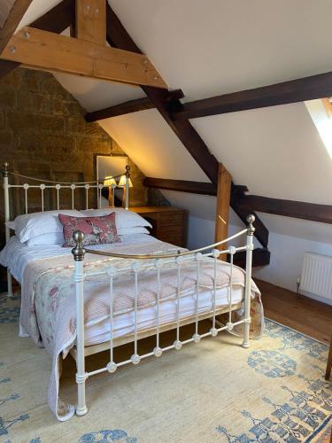 a bedroom with a white bed in a attic at Daffodil in Whitby