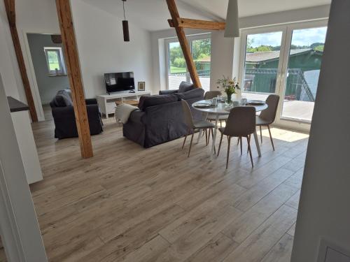 a living room with a table and a couch at Schwalbennest in Steenfeld