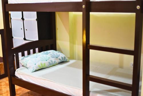 a bunk bed with a pillow on the bottom bunk at Point Vista Transient Accomodation in Daet