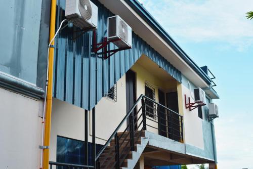 a building with stairs and a clock on the side at Point Vista Transient Accomodation in Daet