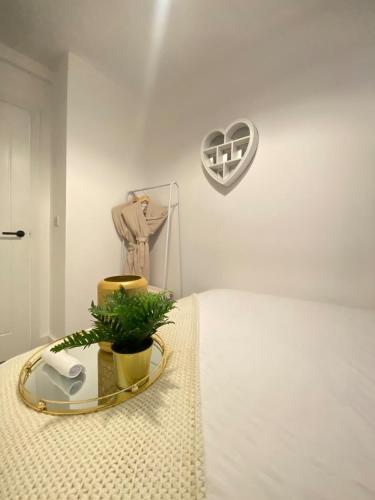 a bedroom with a bed with a heart on the wall at Modern Luxury Escape Suite In The Heart of Urmston Town Centre in Urmston