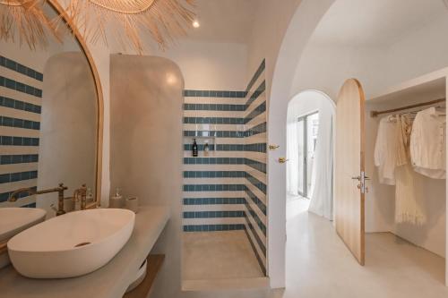 a bathroom with a white sink and a large mirror at Searenity Villas in Rivière Noire