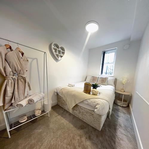a small bedroom with a bed and a mirror at Modern Luxury Escape Suite In The Heart of Urmston Town Centre in Urmston