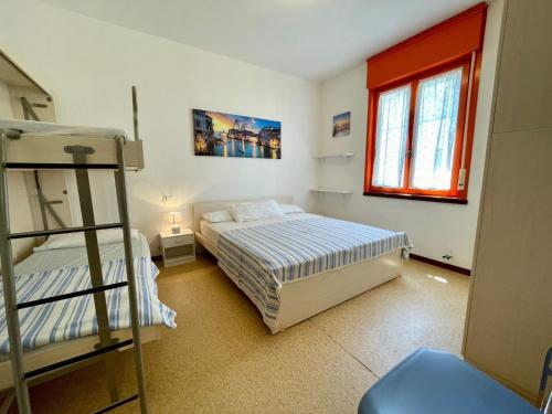 a bedroom with two bunk beds and a ladder at Flat in Porto Santa Margherita in Porto Santa Margherita di Caorle